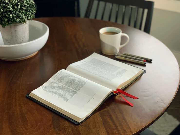 a table with a book and pen sitting on it