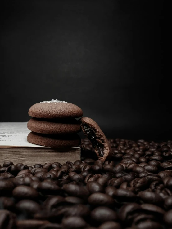 a stack of chocolate cookies with some coffee beans