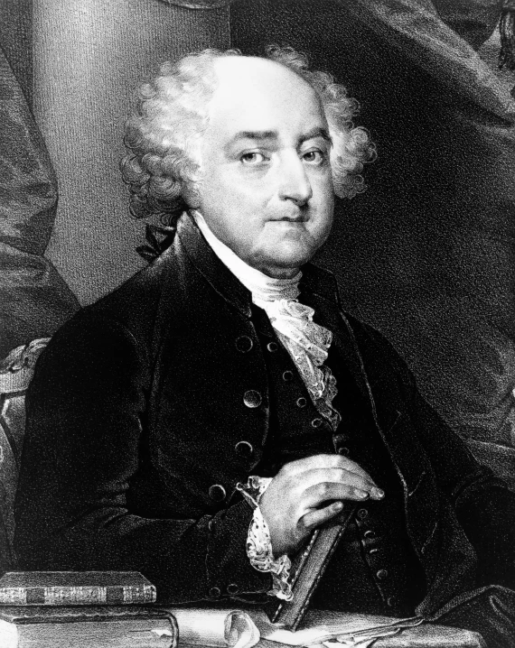 a man with white hair wearing a black jacket