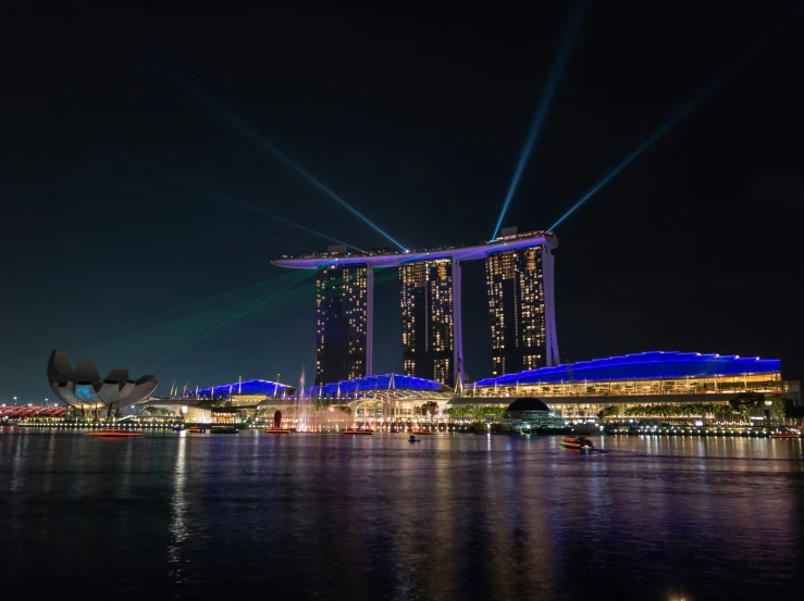 a city skyline is lit up at night with a long exposure