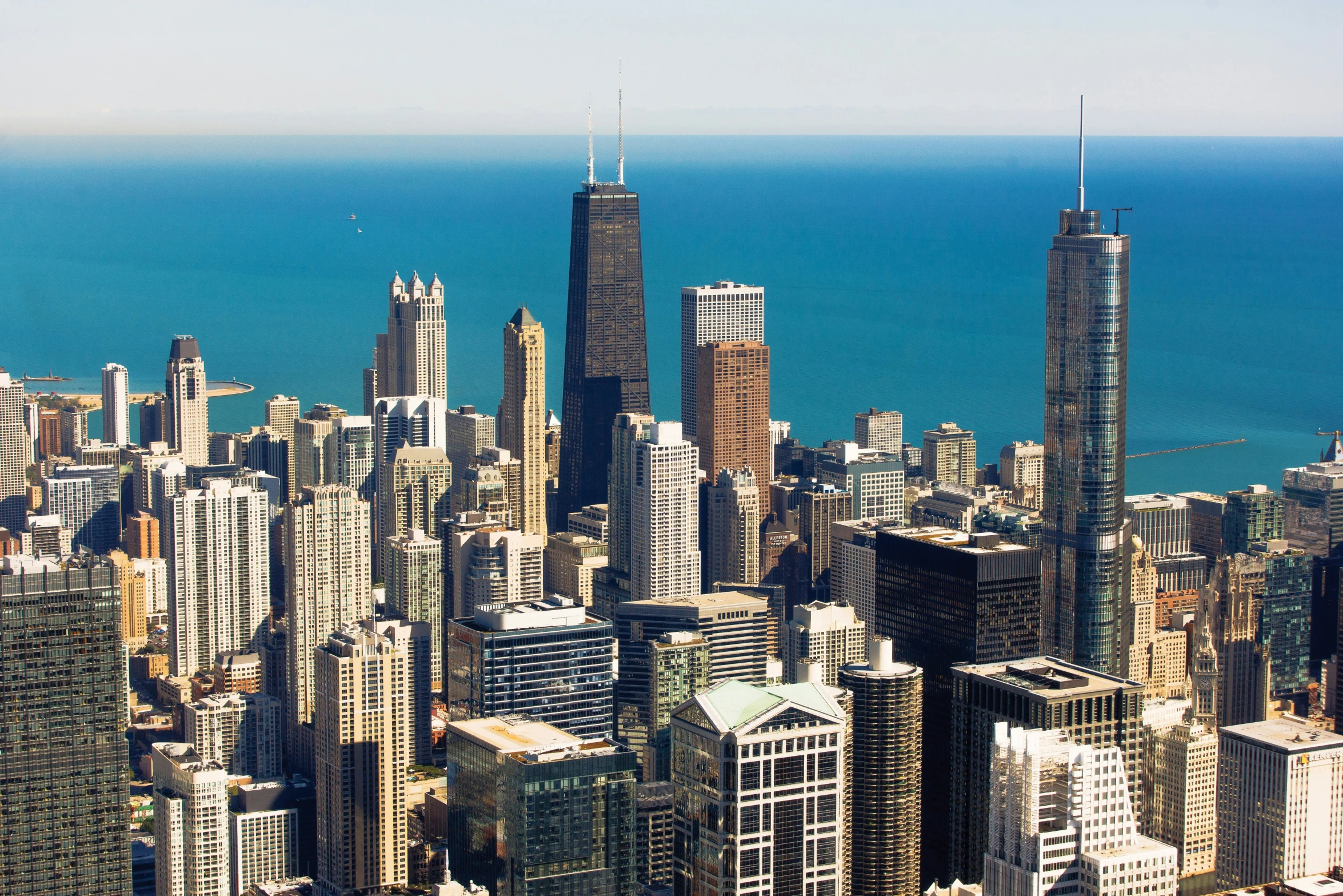 an aerial view of a city area and blue water