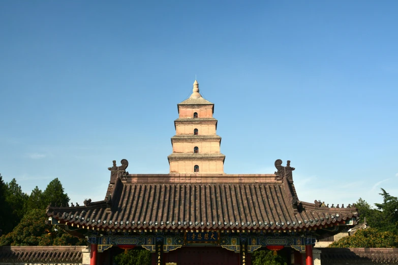 a tall clock tower next to a fence