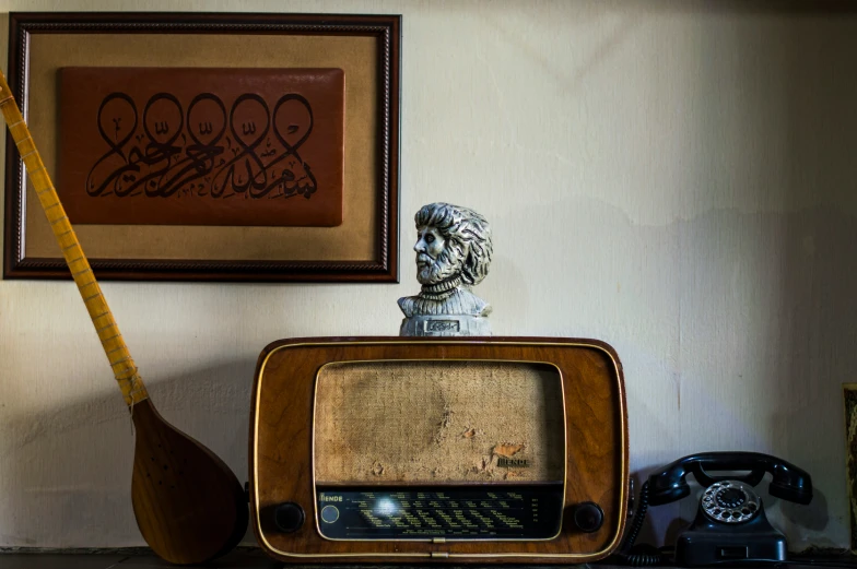 an old tv on the shelf next to a guitar