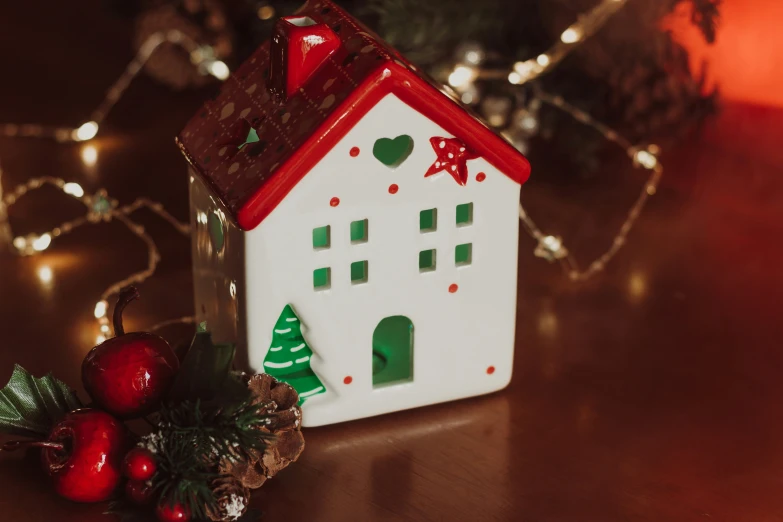 a house ornament with christmas decorations around it