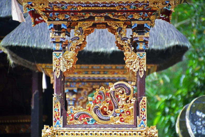 an ornate wooden structure next to trees