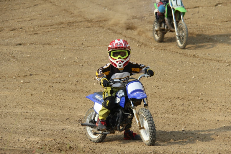 the boy is riding his motorcycle around the track