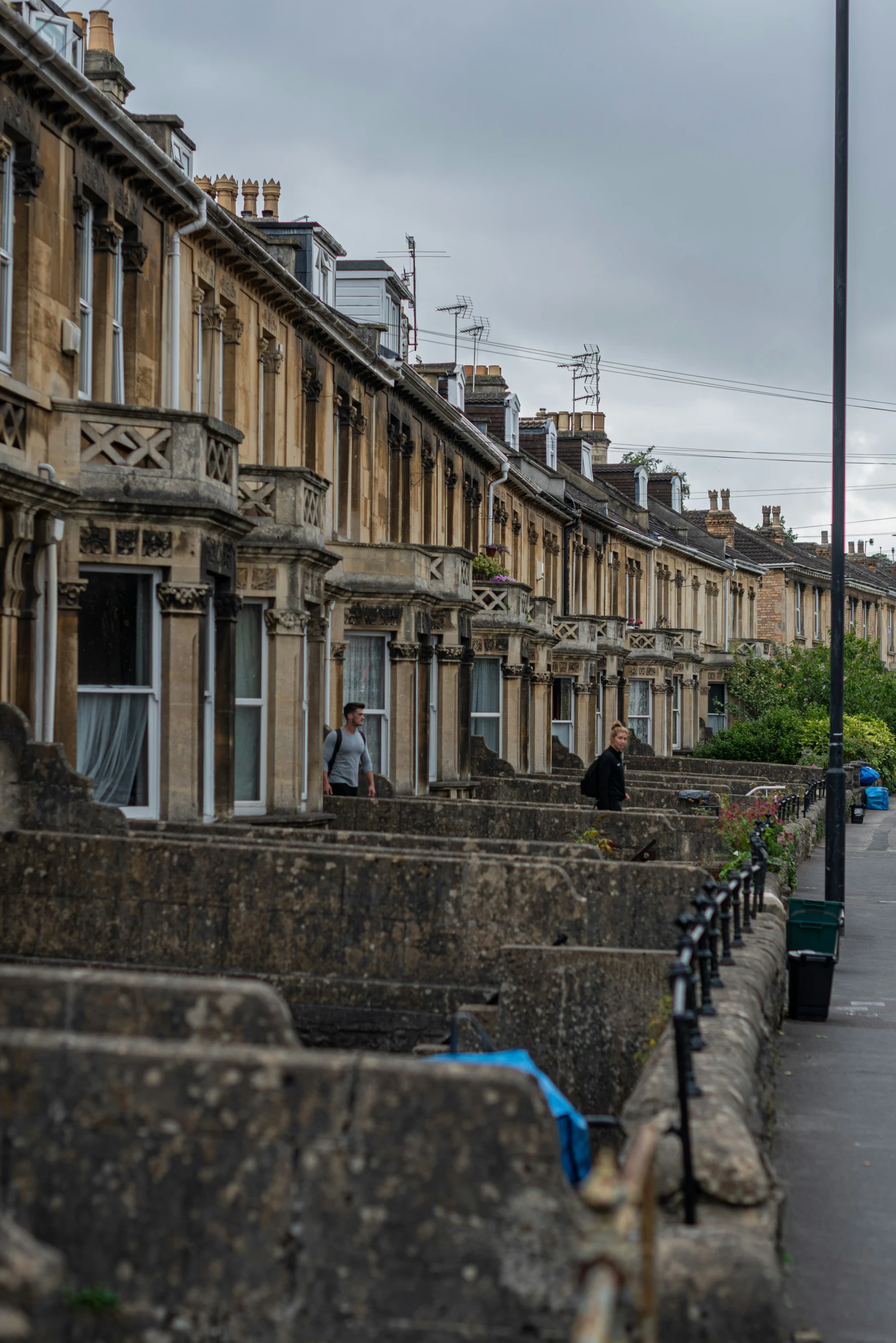 some people sitting on the ledges of buildings