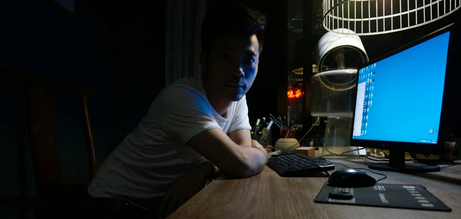 man sitting at the table, on his computer
