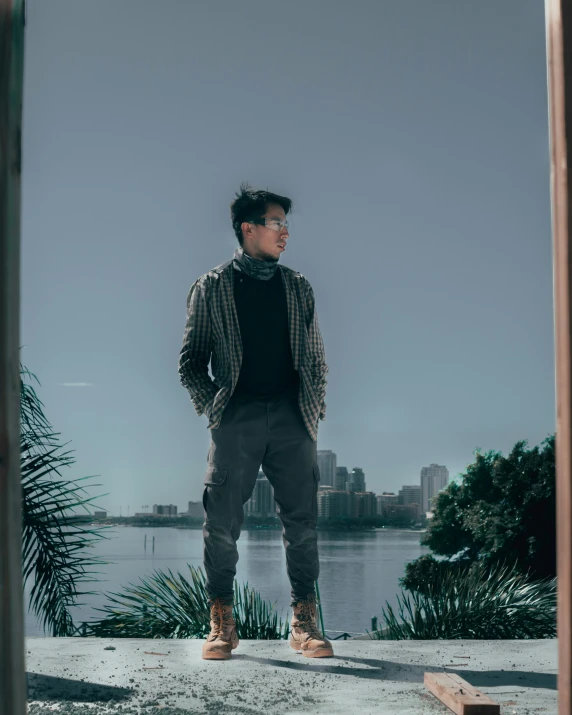 a man standing on the edge of a cement structure near a body of water