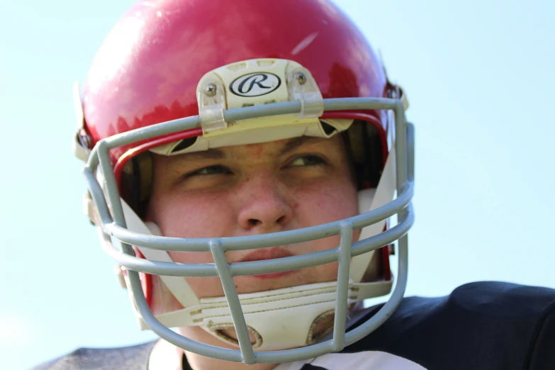 a person in a red football helmet and a white jersey