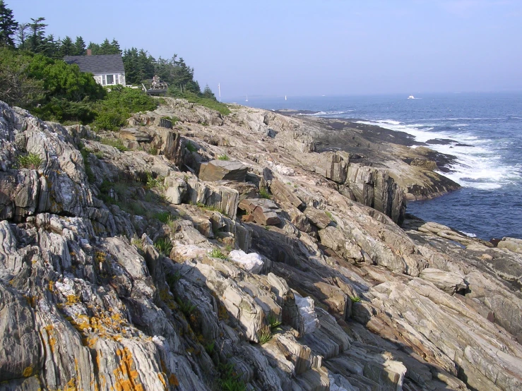 the view from above a rocky cliff overlooking the ocean