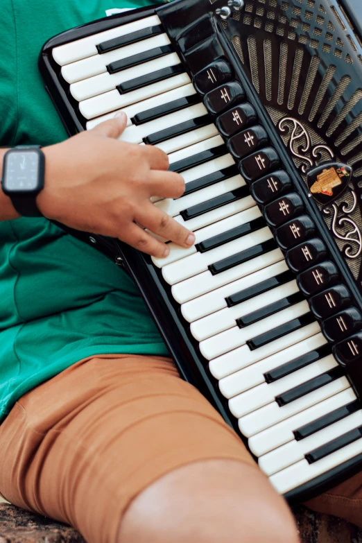 the woman is playing an accordion while wearing her watch