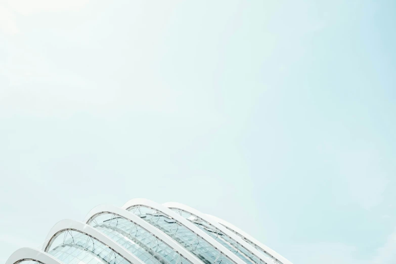 a large plane flying in the air next to a building