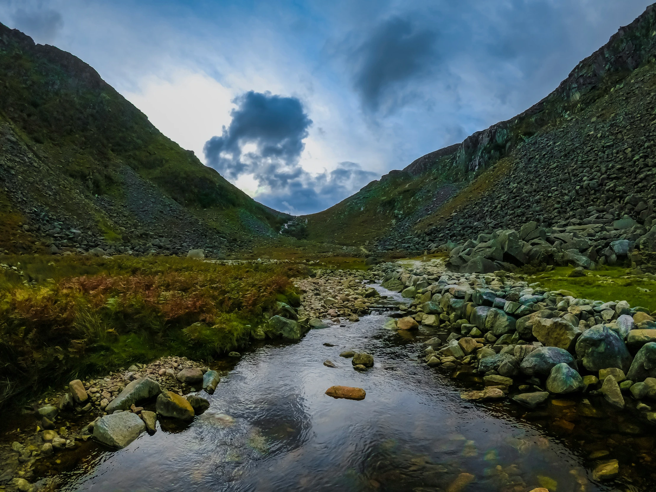 the rocks are reflecting in the water as it flows