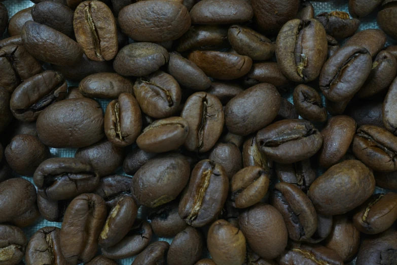 a close up of a group of coffee beans