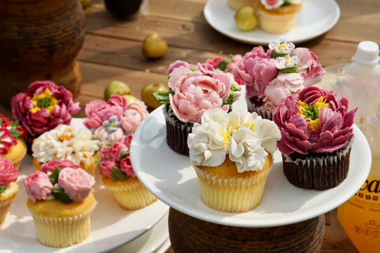 several cupcakes sitting on a table next to a bottle