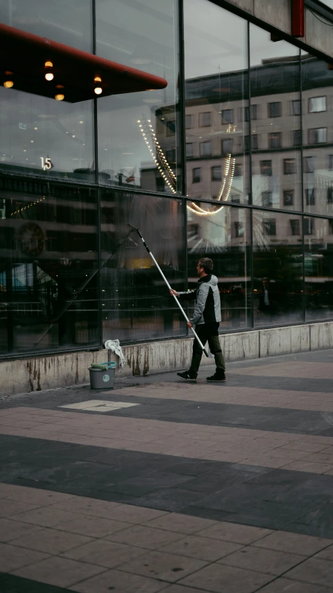a man is standing outside with a pole