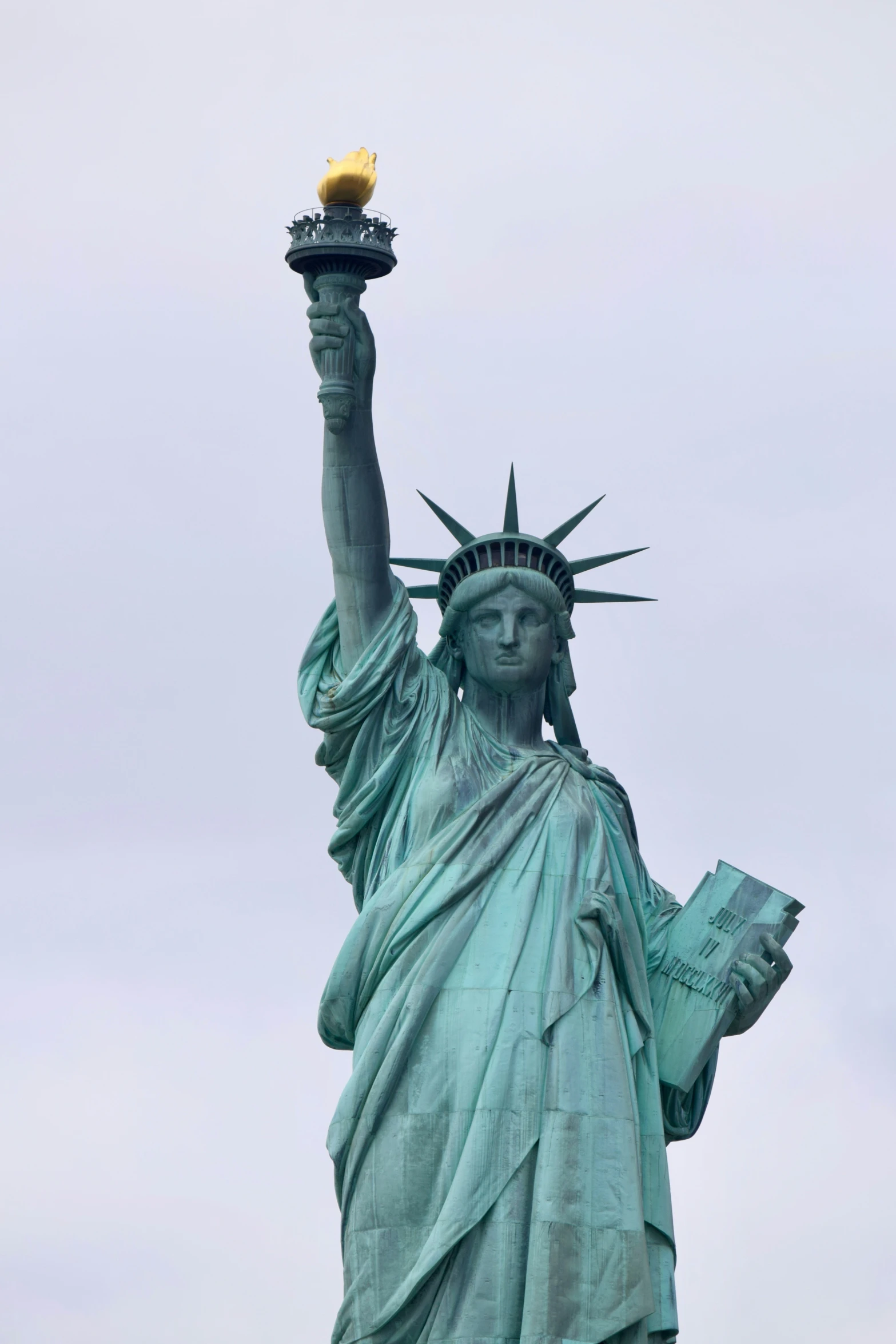 a big statue of liberty with an object in its hand