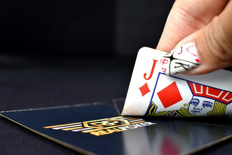 a person places playing cards onto a card