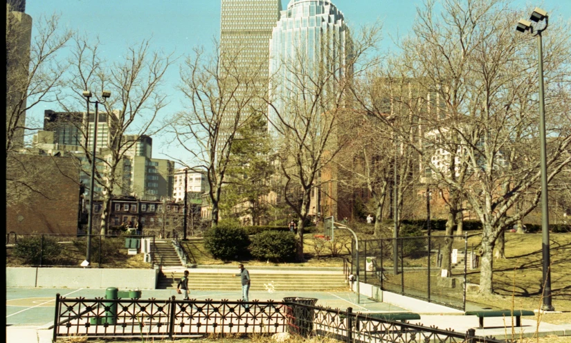 a couple of park benches in front of a tall building