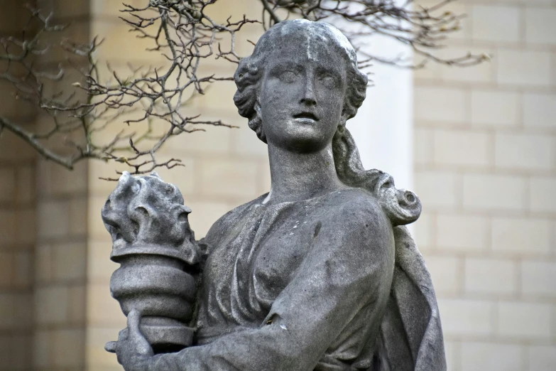 a close up of a statue near a tree