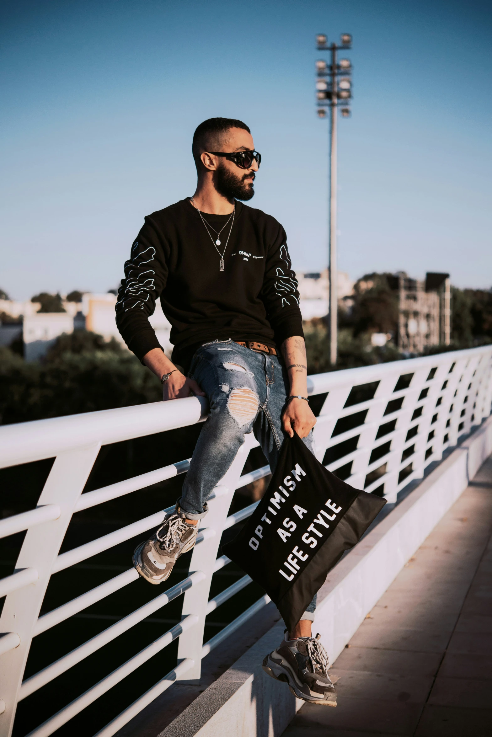 the man is posing for a picture on the bridge