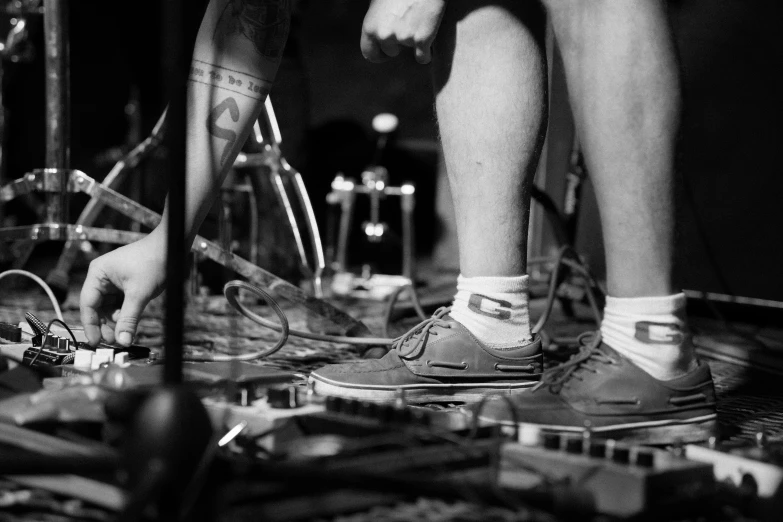 a person's feet are shown standing near a bicycle