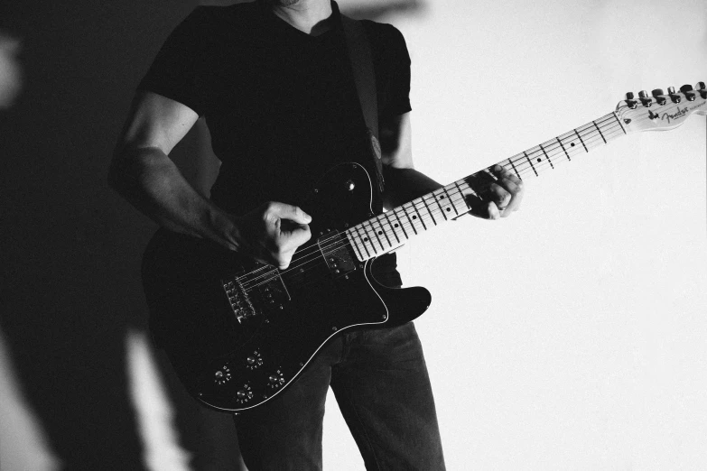 a man is playing an electric guitar indoors