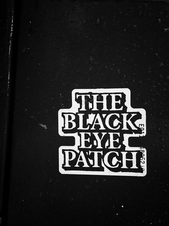 a close up of a sticker on the side of a black phone