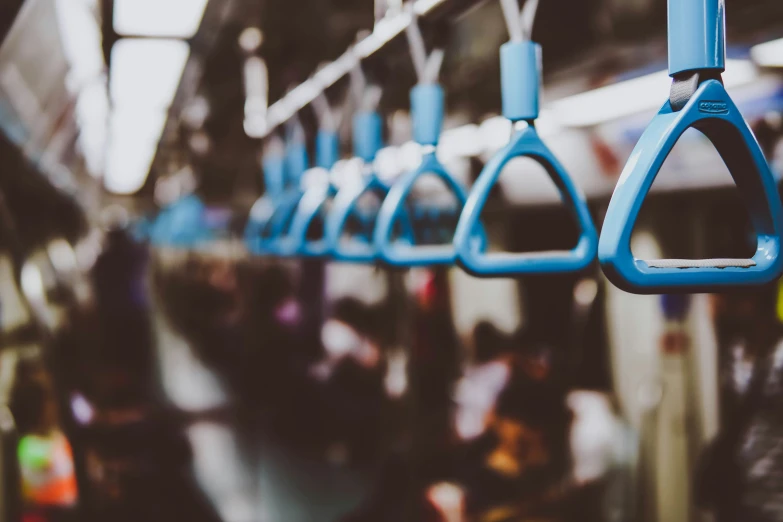 a group of blue handles hanging from the ceiling