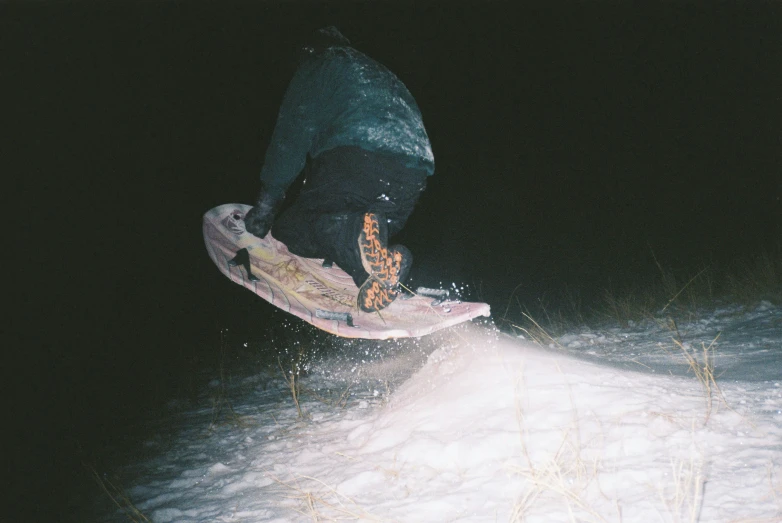 a person riding a snow board on a snowy surface