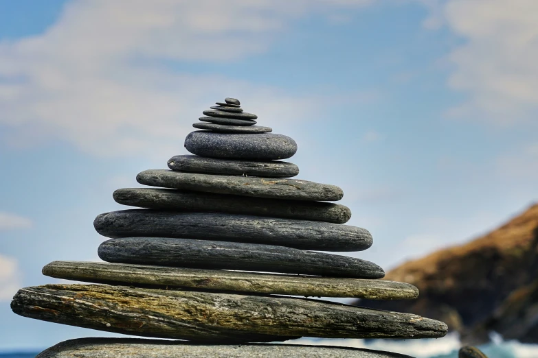 a tower of rocks on a beach on a sunny day