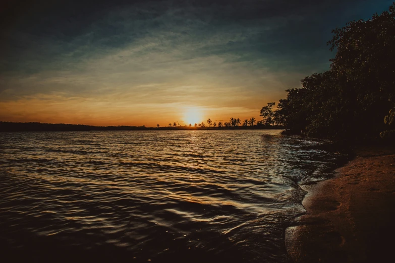 a calm river with sun reflecting in the water