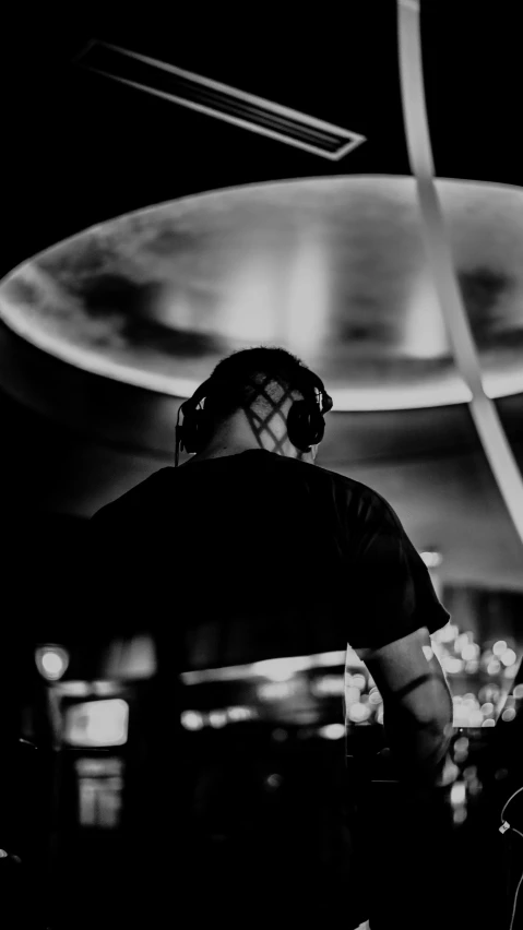 man with goggles on playing music in a studio