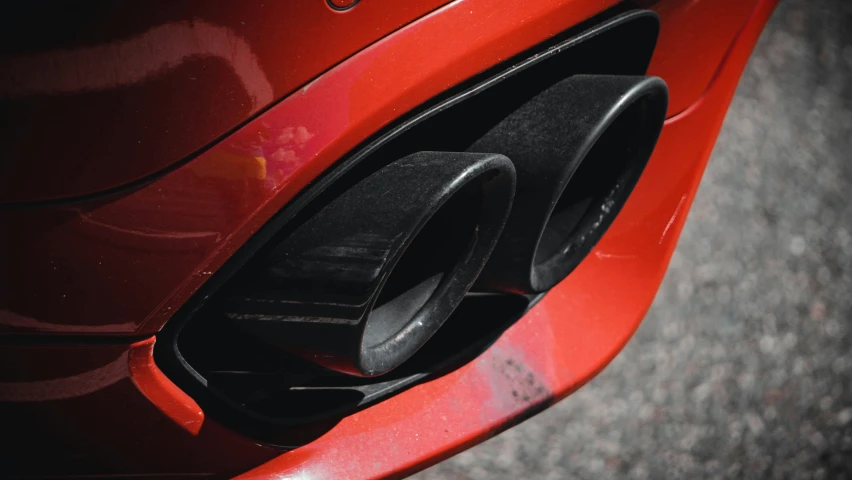 a red sports car is plugged in to a vehicle charge