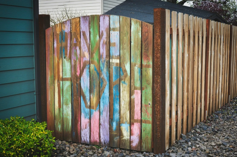 this is an old wooden fence with graffiti