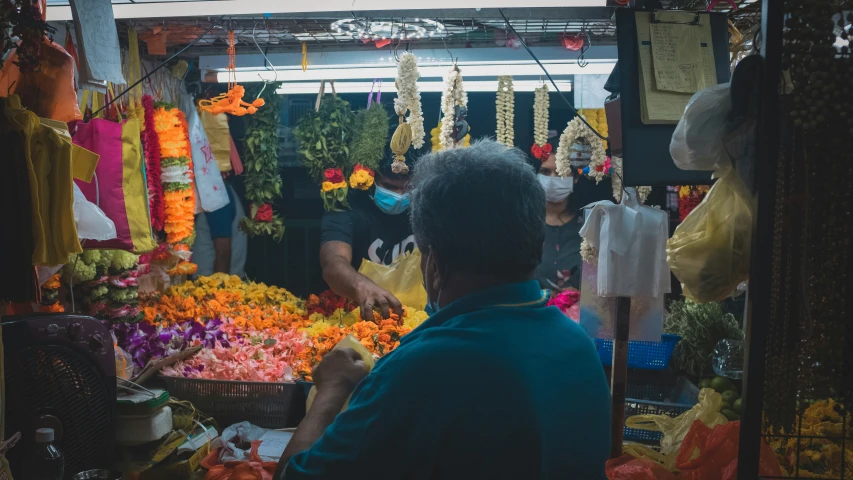 a man in a store with a lot of flowers