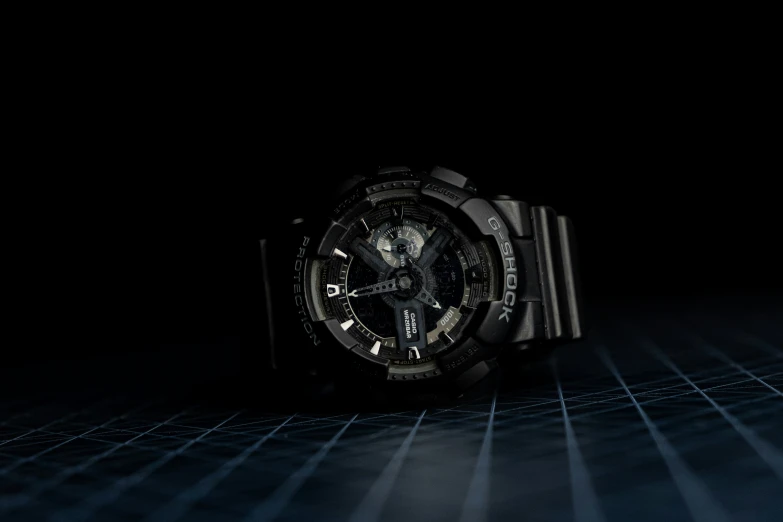 a wrist watch in a dark room with blue rays