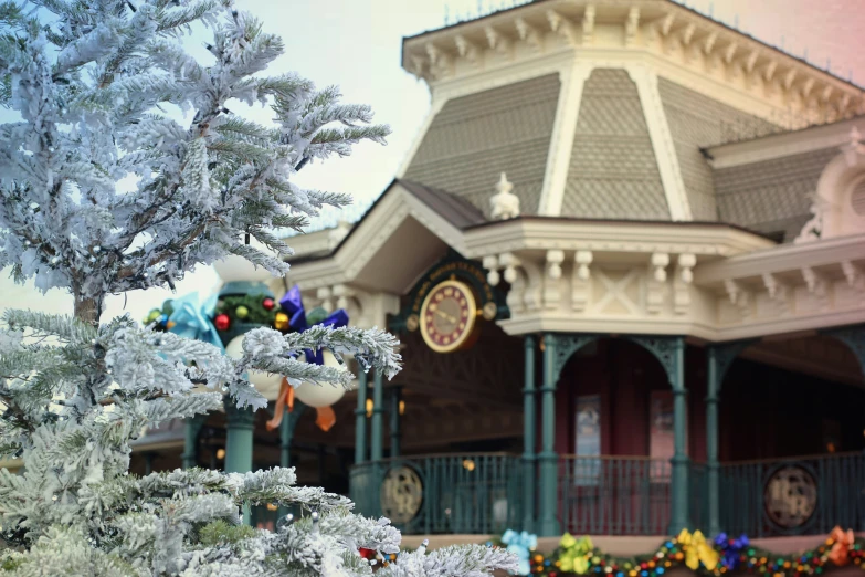 the snow - covered trees outside of the house are festooned with colorful beads