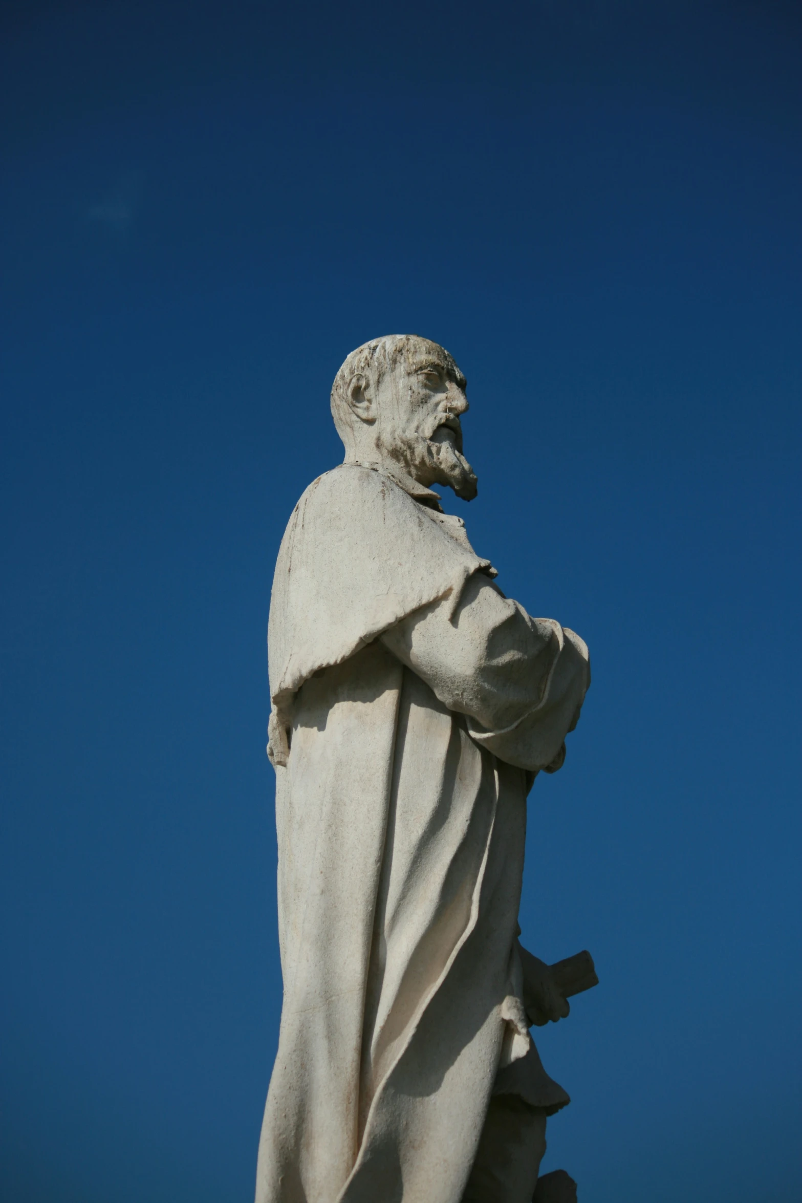 the statue is white and has a long beard