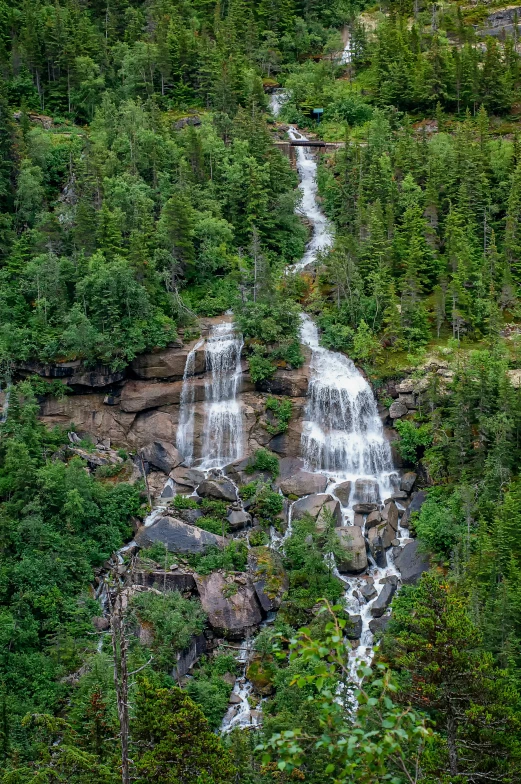 the large waterfall is very high in the mountains