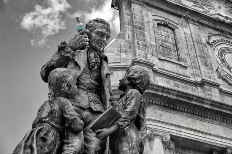 a statue is shown in front of a tall building