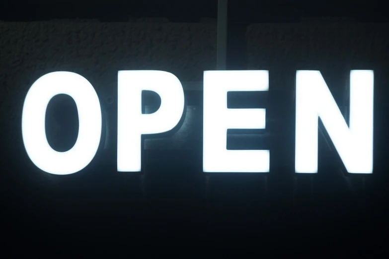 there is a neon sign that says open on it