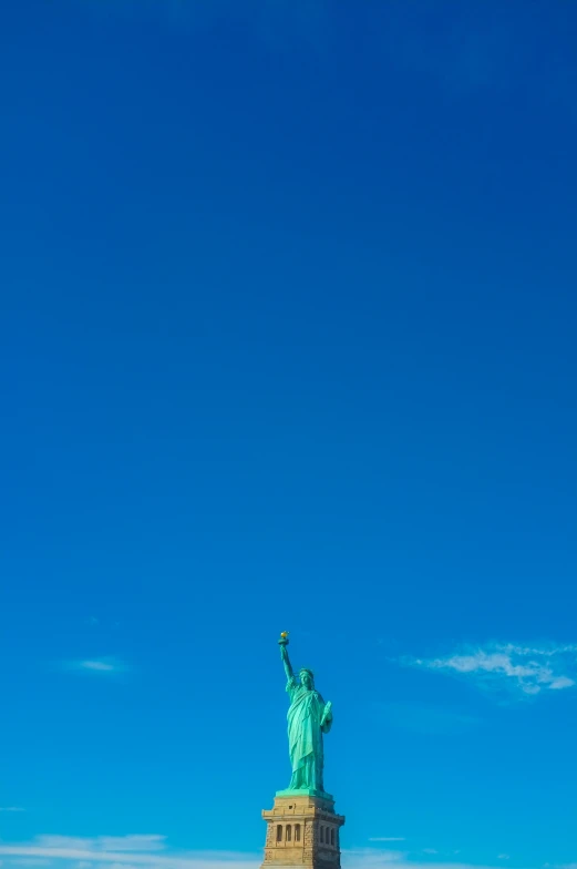 a statue in a park next to a clock tower