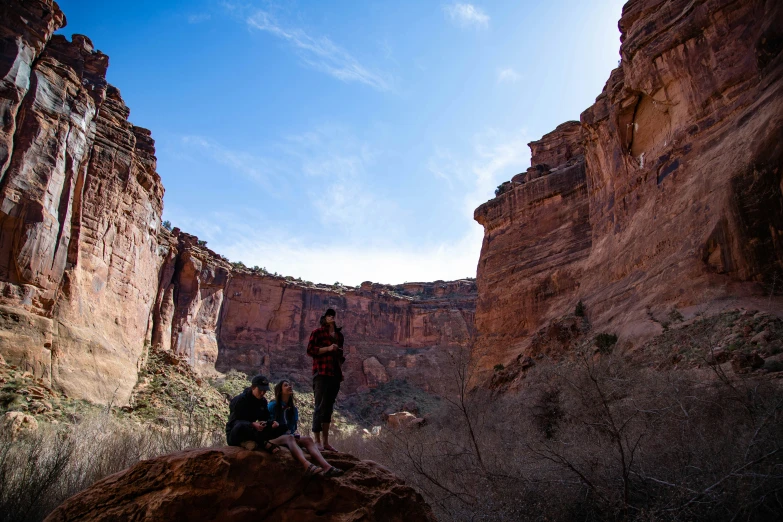 a couple of people that are standing on some rocks