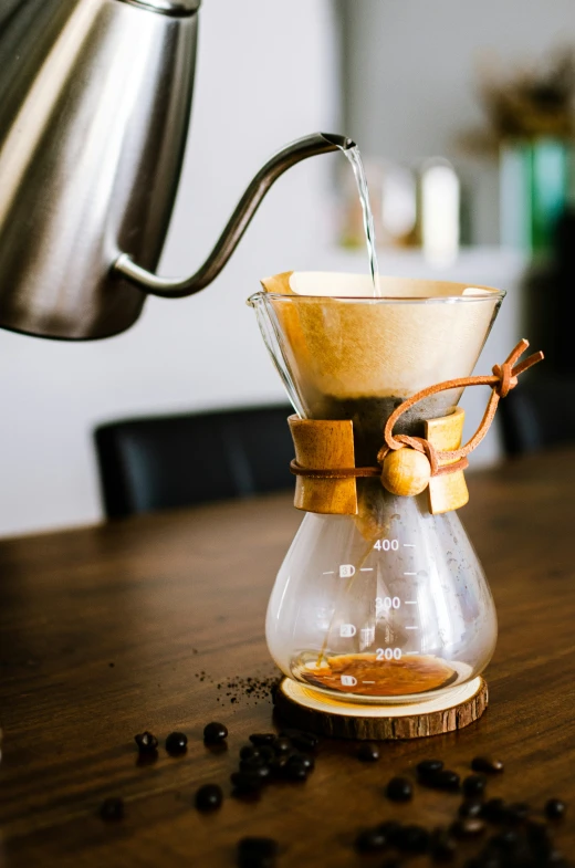 the water is being poured into a glass pitcher