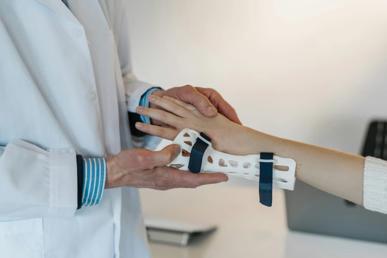 two people touching hands and a man in white medical attire