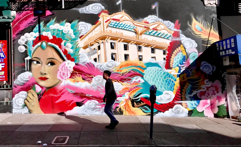 man walking past colorful building and woman in front of her