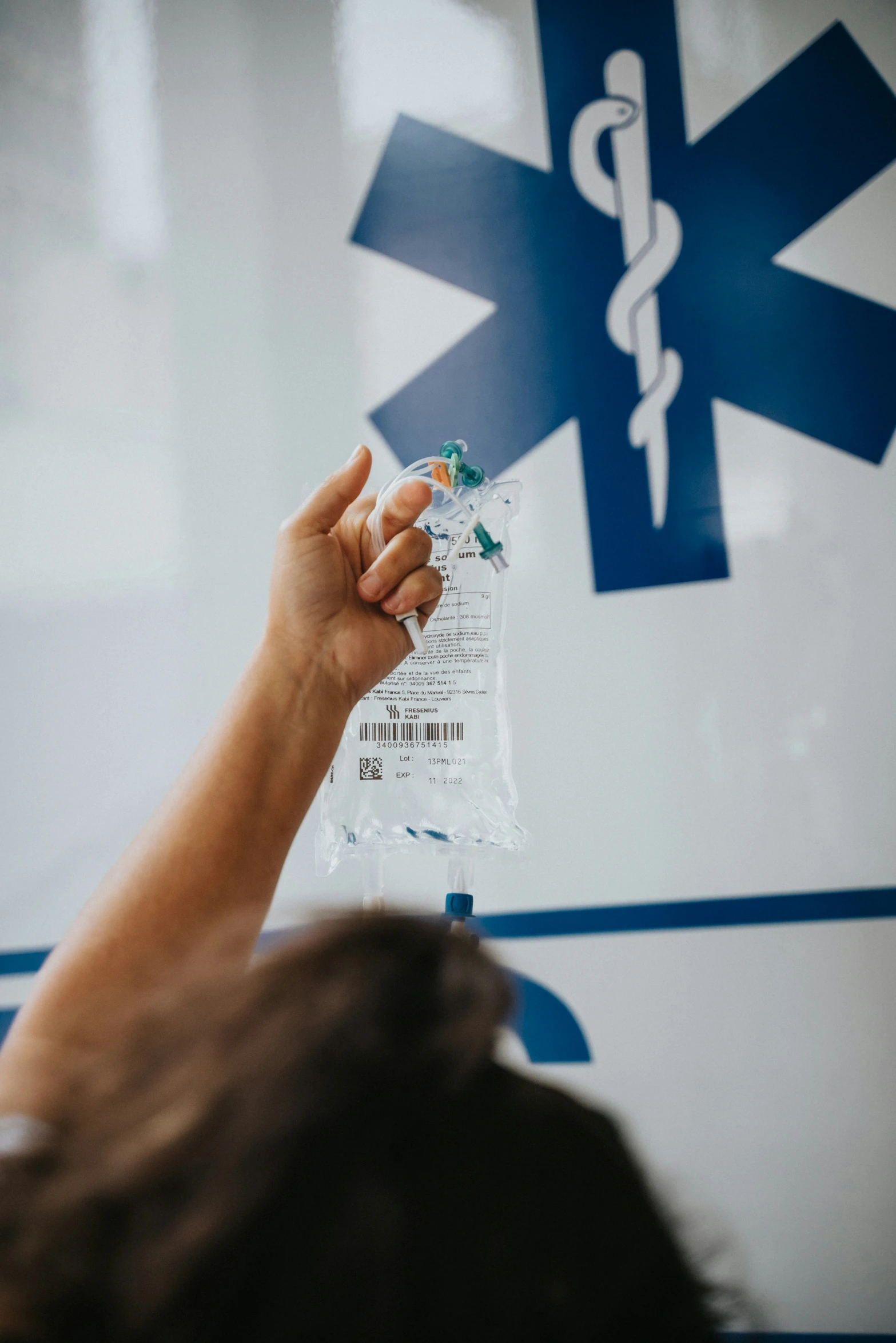 a hand holding a medicine kit with a stethoscope on it