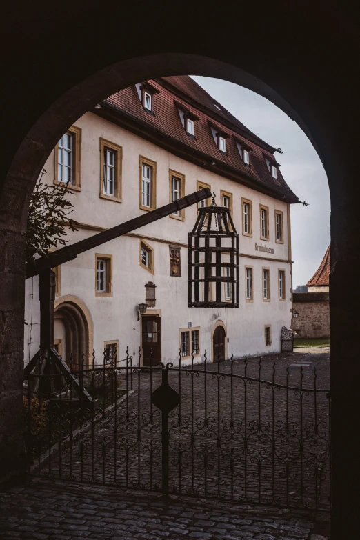 there is a house in the background through an arch